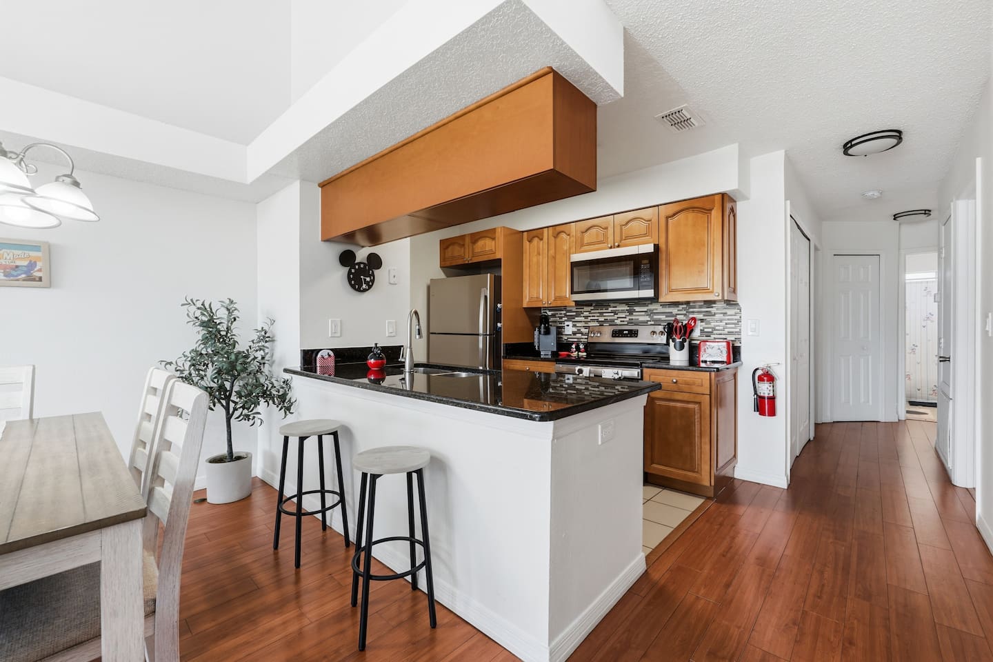 Full kitchen with breakfast bar, granite counters, and an adjoining dining space at an Ellis Getaways vacation home